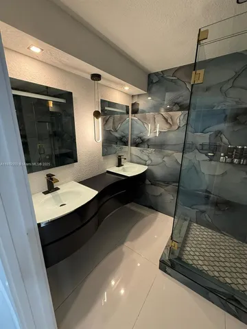 a bathroom with a sink and mirror
