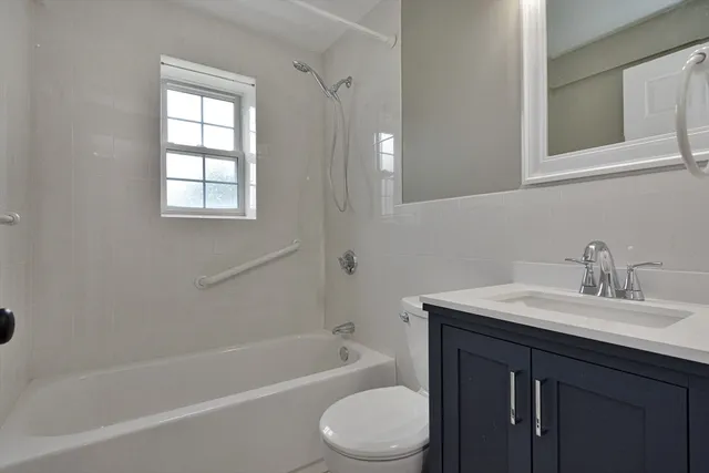 a bathroom with a sink toilet a bathtub and vanity