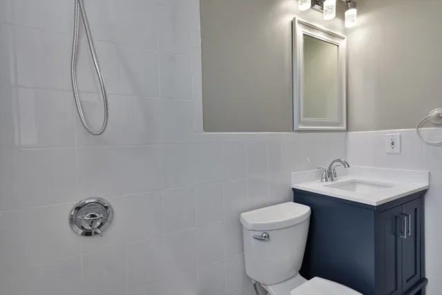 a bathroom with a sink a toilet and a mirror