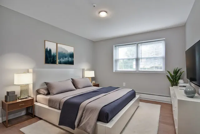 a bedroom with a large bed and a window