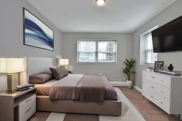 a bedroom with a large bed and a flat screen tv