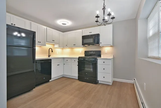 a kitchen with stainless steel appliances a refrigerator sink and microwave