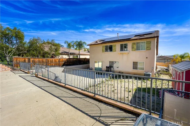 an aerial view of a house with swimming pool and garden