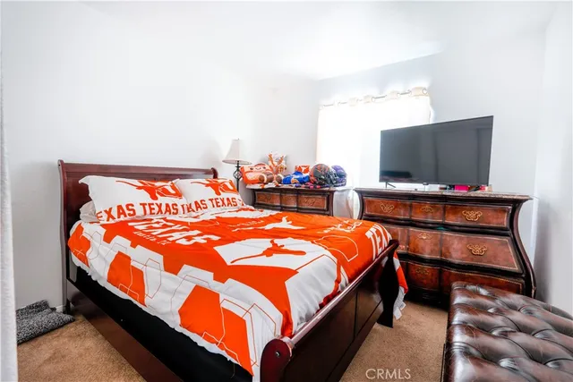 a bed sitting in a bedroom next to a window