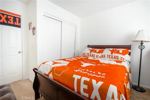 a living room with a bed furniture and a flat screen tv