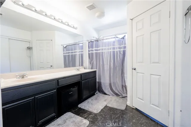 a en suite bathroom with a sink and a mirror