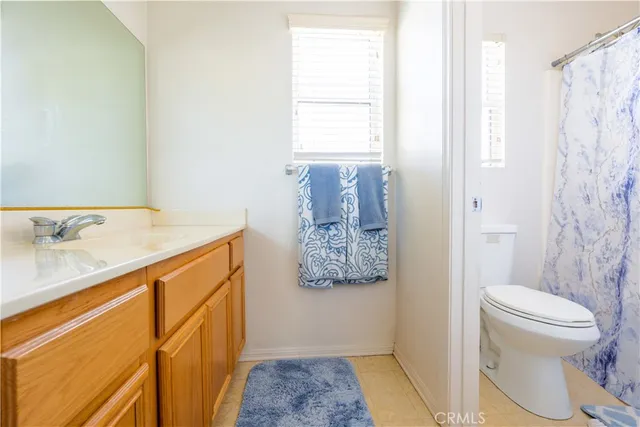 a bathroom with a sink a toilet and shower curtain