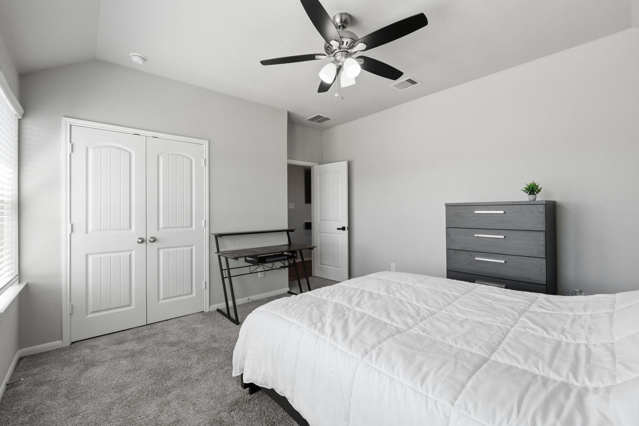 4334 Umber Shadow Drive Spring, TX 77386 - Photo 26 of 45 Secondary bedroom offers a functional layout with a walk-in closet and convenient access to the upper-level living spaces.