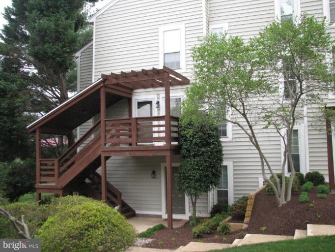 9935 Oakton Terrace Road, Unit 24 Oakton, VA 22124 - Photo 1 of 1 a view of a house with a yard