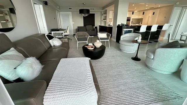 a living room with furniture a dining table and chairs