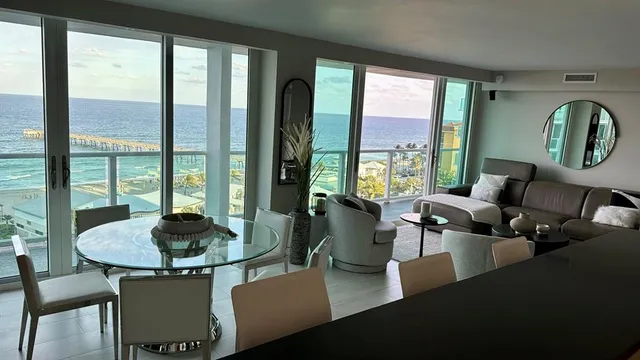 a living room with furniture and a floor to ceiling window