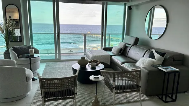 a living room with furniture and a potted plant