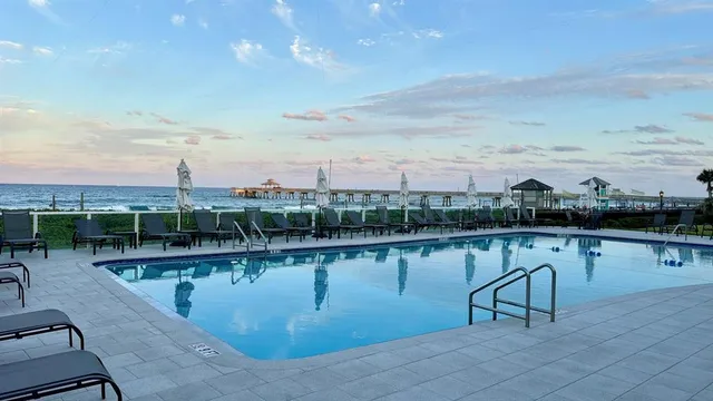a view of a lake with a table and chairs