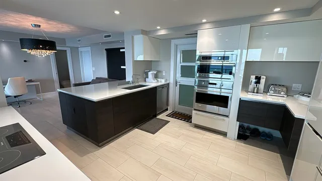 a kitchen with stainless steel appliances a sink stove and refrigerator