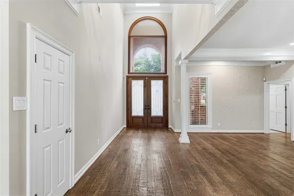 a view of an entryway with wooden floor