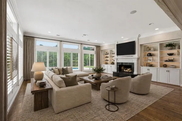 a living room with furniture a fireplace and a flat screen tv
