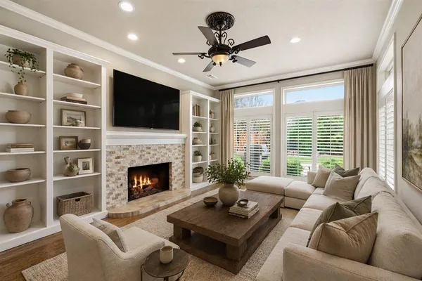 a living room with furniture a fireplace and a flat screen tv