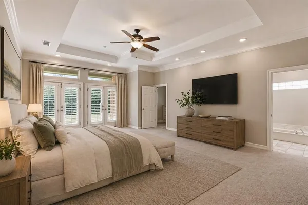 a bedroom with a large bed and a flat screen television