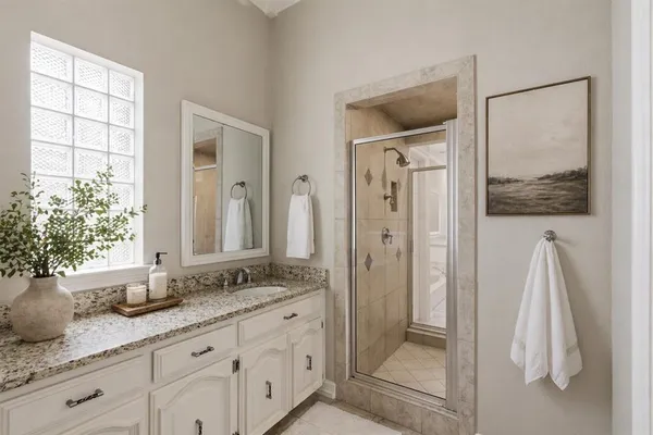 a bathroom with a granite countertop sink and a mirror