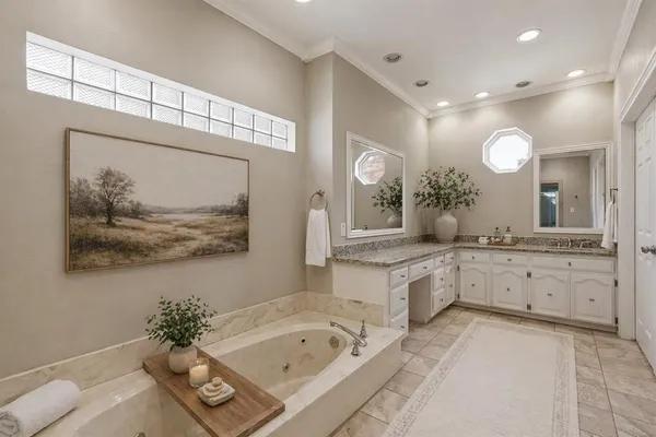 a spacious bathroom with a tub a double vanity sink and a mirror