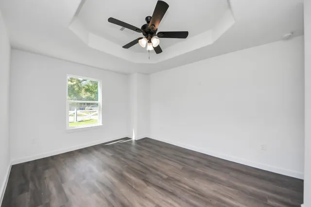 wooden floor in an empty room with a window