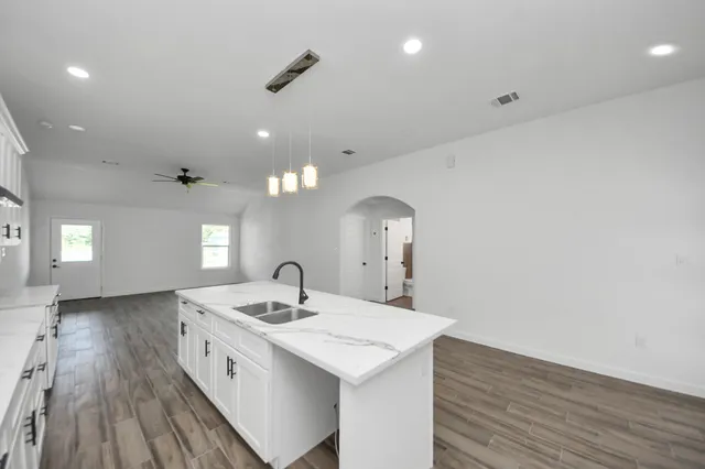 a bathroom with a sink a large mirror and vanity