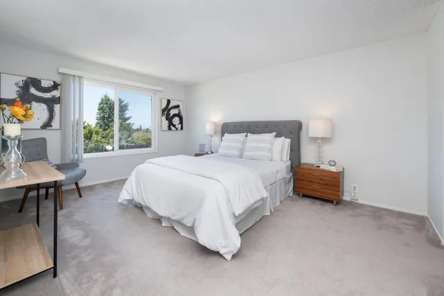 a spacious bedroom with a bed and a table