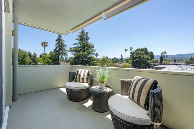 a view of a chair and tables on the balcony