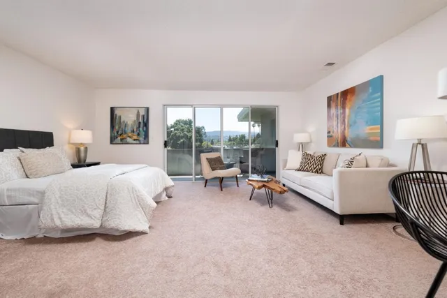 a spacious bedroom with a bed and a couch