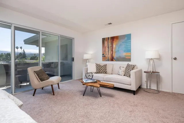 a living room with furniture and a chair