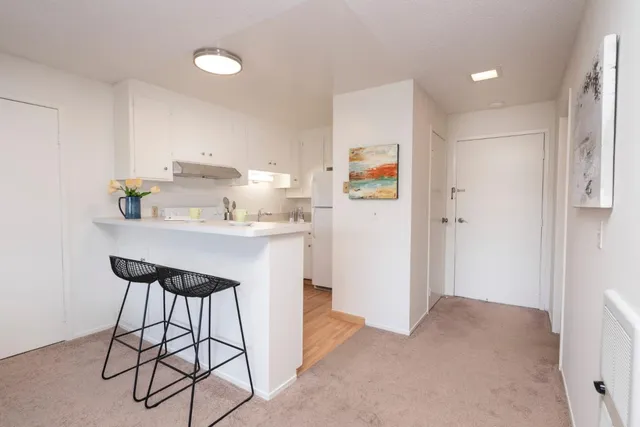 a kitchen with stainless steel appliances a sink cabinets and a refrigerator
