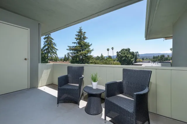 a view of a chair and table in the balcony