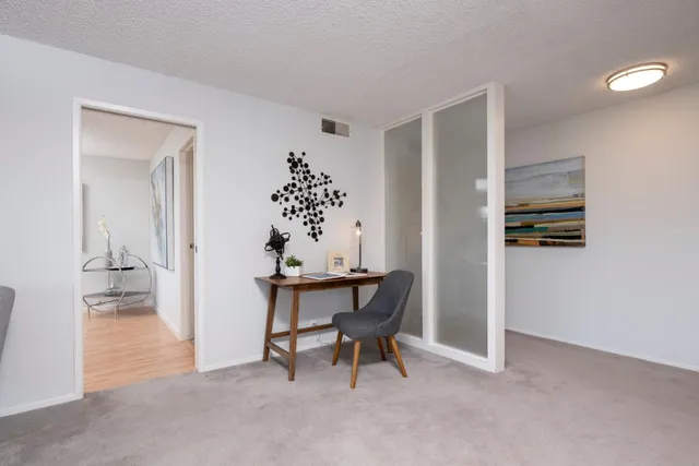 a workspace room with furniture and wooden floor