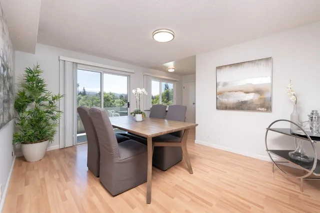 a view of a dining room with furniture and window
