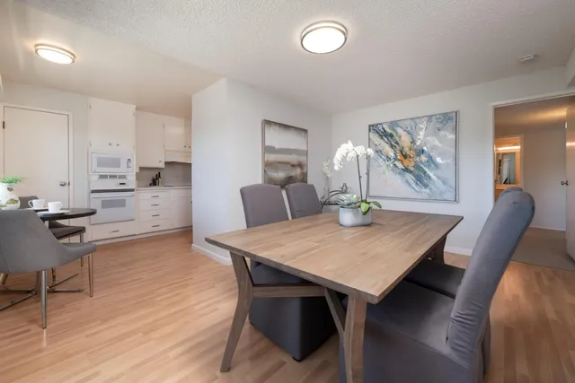 a view of a dining room with furniture and wooden floor
