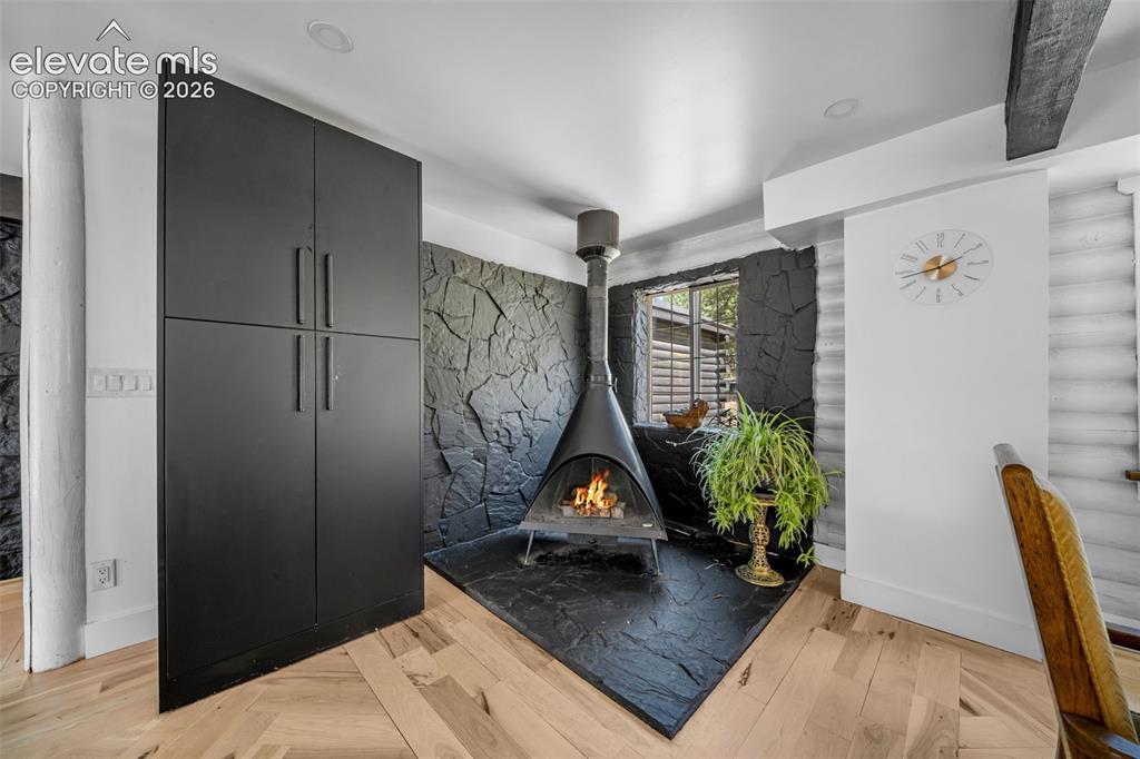 986 Apache Road Florissant, CO 80816 - Photo 12 of 50 Midcentury woodburning stove in the DR/kitchen