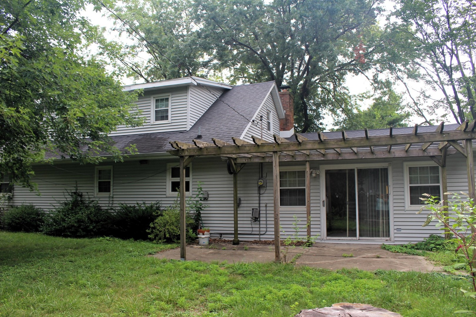 55 Hillcrest Drive Clinton, IL 61727 - Photo 18 of 22 a view of a house with a yard and a large tree