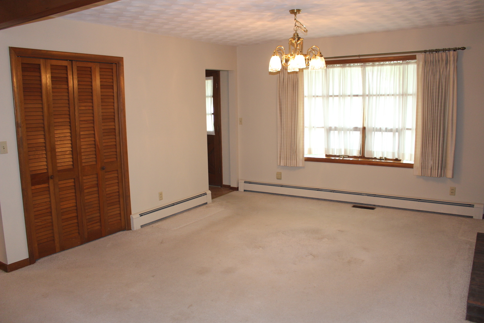 55 Hillcrest Drive Clinton, IL 61727 - Photo 6 of 22 an empty room with windows and chandelier