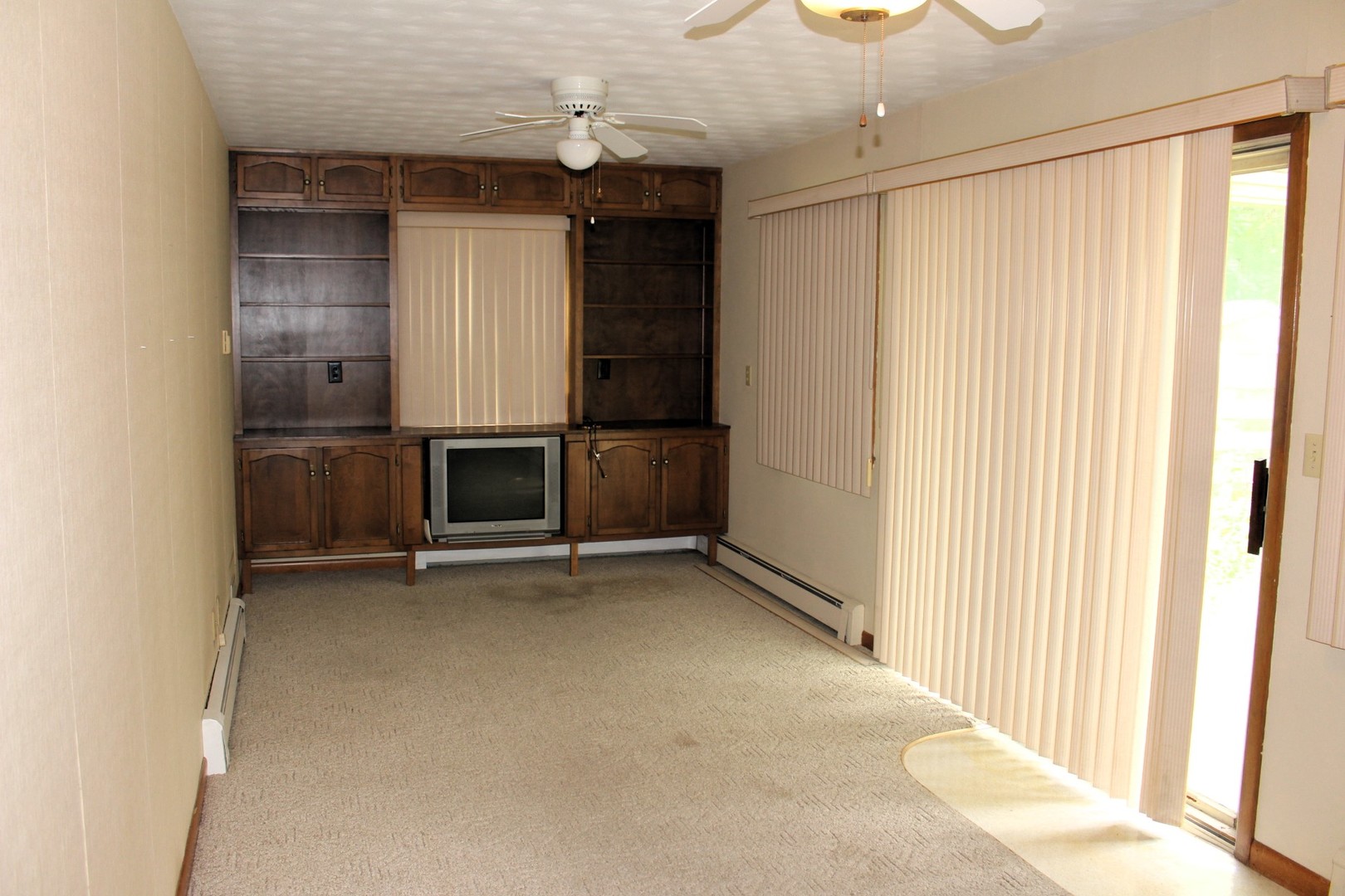55 Hillcrest Drive Clinton, IL 61727 - Photo 10 of 22 an empty room with a fireplace and cabinet
