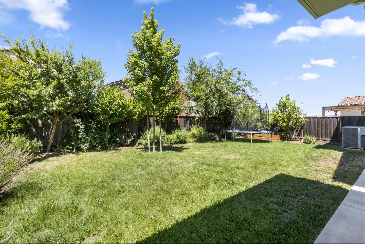 1237 Viognier Way Gilroy, CA 95020 - Photo 13 of 47 a backyard of a house with a yard and outdoor seating
