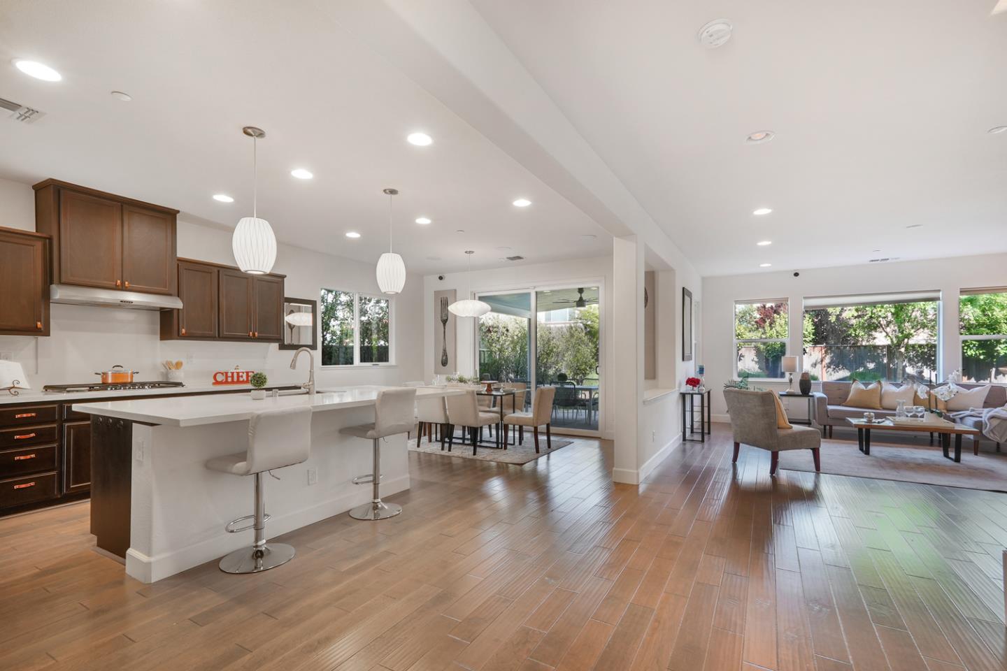 1237 Viognier Way Gilroy, CA 95020 - Photo 17 of 47 a kitchen with a table chairs stove and wooden floor