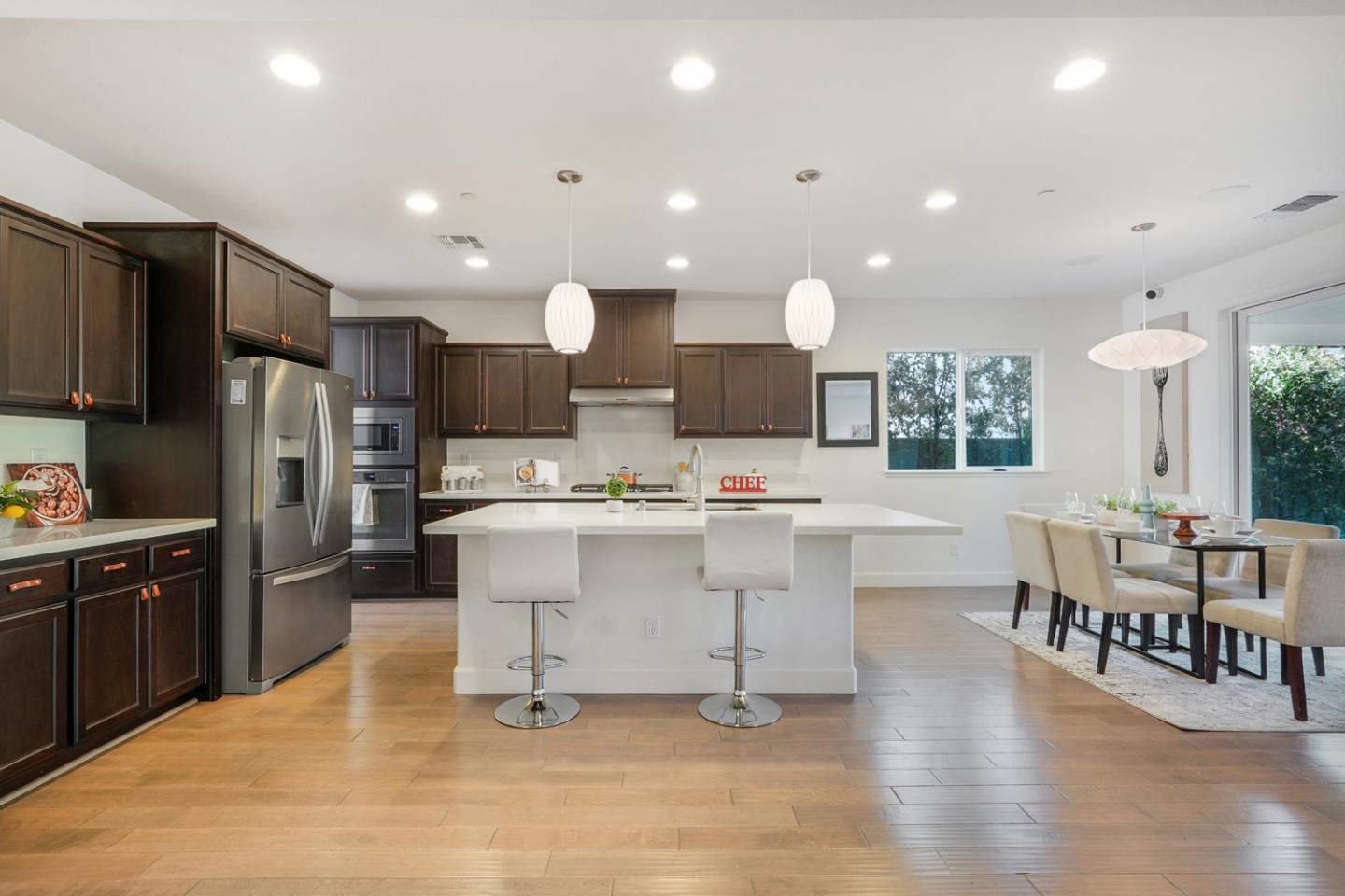 1237 Viognier Way Gilroy, CA 95020 - Photo 18 of 47 a large white kitchen with lots of counter space and stainless steel appliances