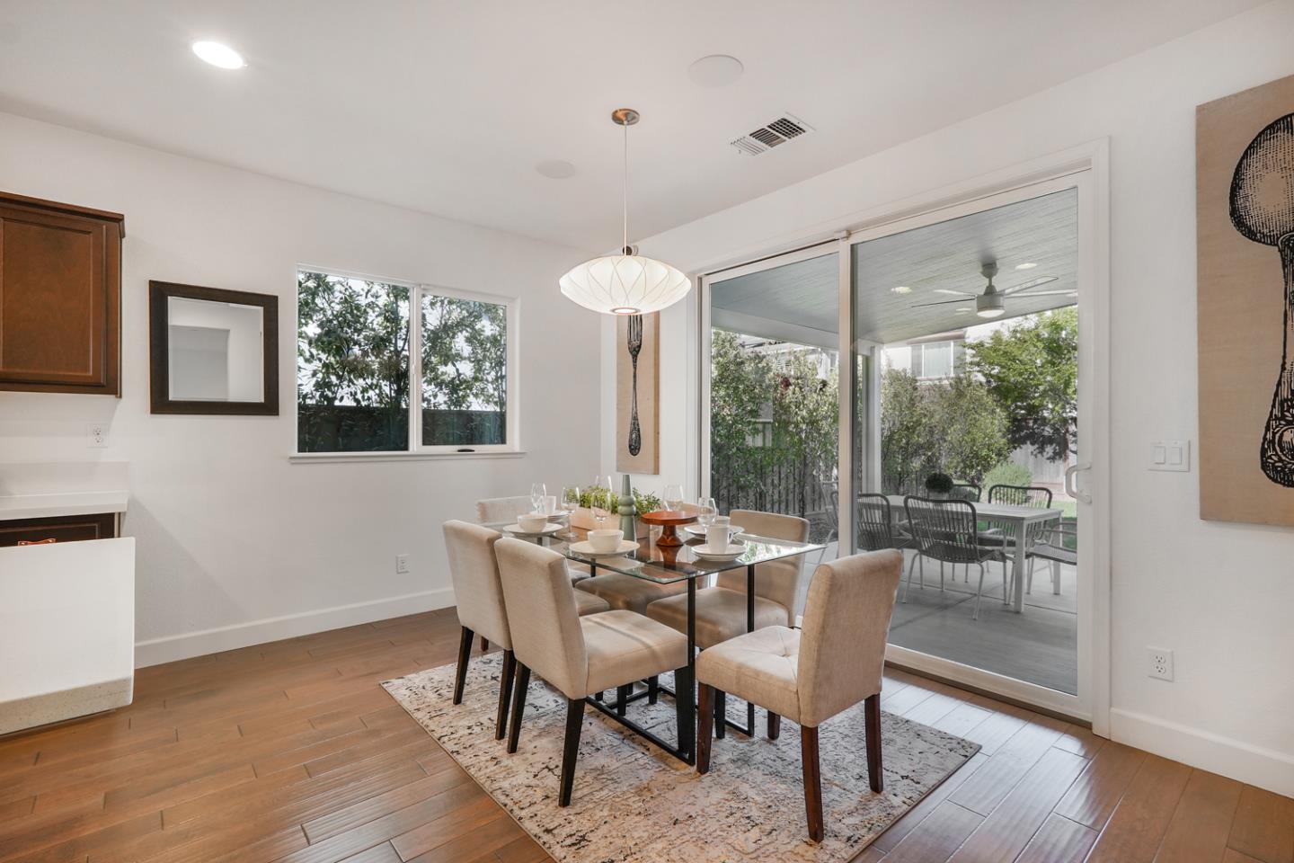 1237 Viognier Way Gilroy, CA 95020 - Photo 19 of 47 a dining room with furniture a chandelier and wooden floor