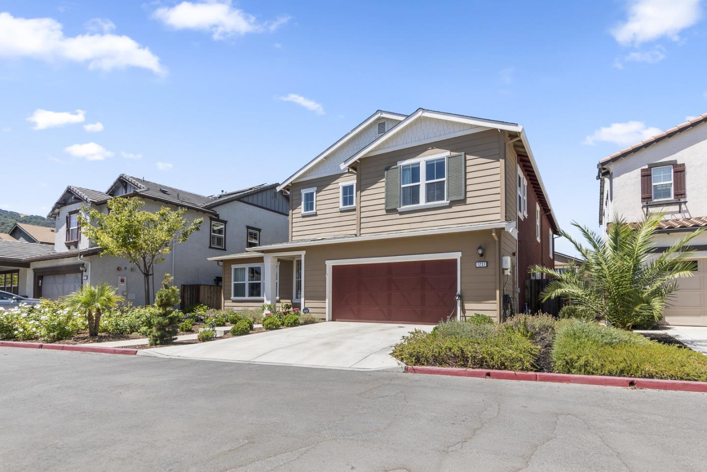 1237 Viognier Way Gilroy, CA 95020 - Photo 7 of 47 a front view of a house with a yard and garage