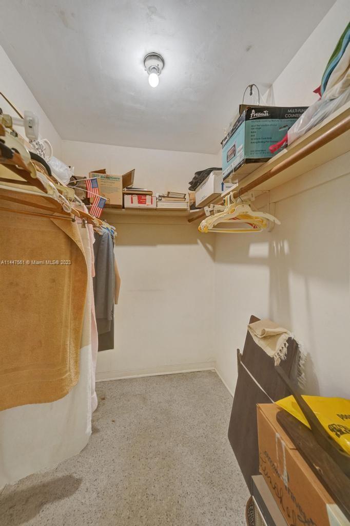5525 Jackson Street Hollywood, FL 33021 - Photo 18 of 91 a view of walk in closet with clothes and shoes