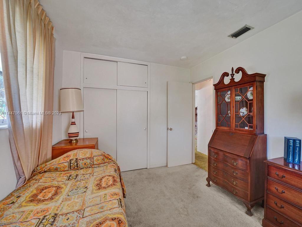5525 Jackson Street Hollywood, FL 33021 - Photo 22 of 91 a bedroom with a bed and a dresser