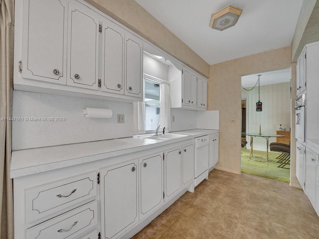 5525 Jackson Street Hollywood, FL 33021 - Photo 29 of 91 a kitchen with white cabinets and sink