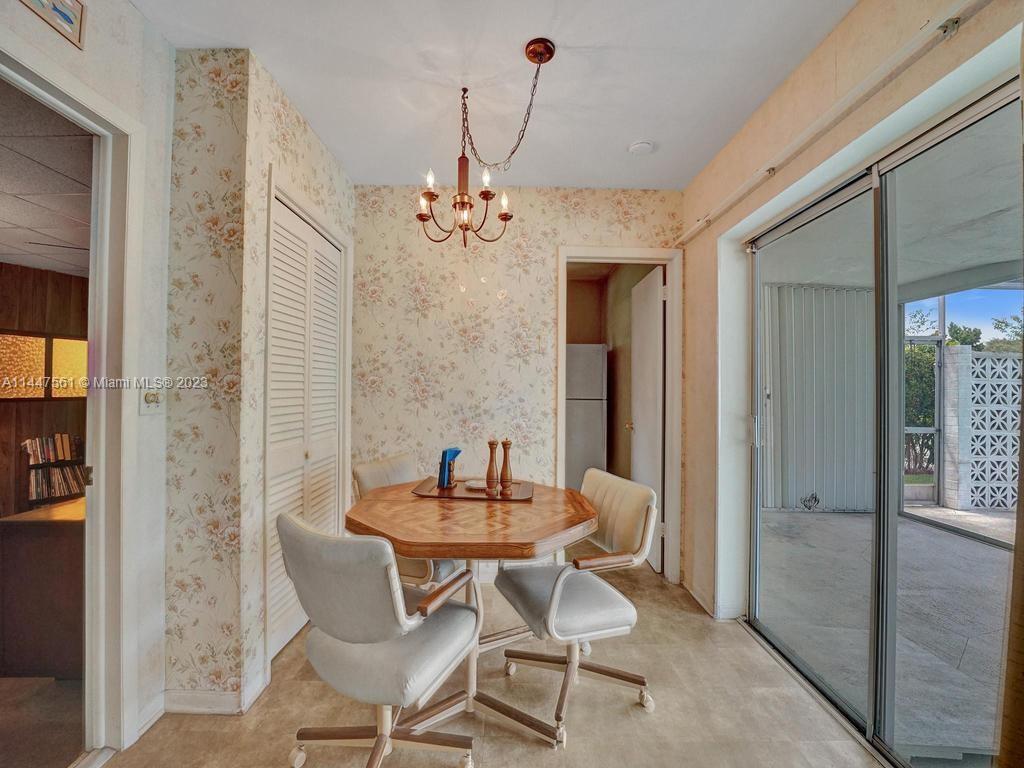 5525 Jackson Street Hollywood, FL 33021 - Photo 30 of 91 a view of a dining room with furniture and chandelier