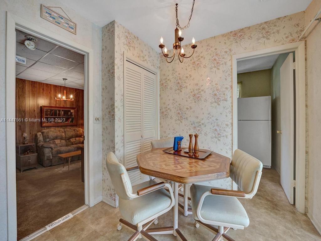 5525 Jackson Street Hollywood, FL 33021 - Photo 31 of 91 a view of a dining room with furniture and a chandelier