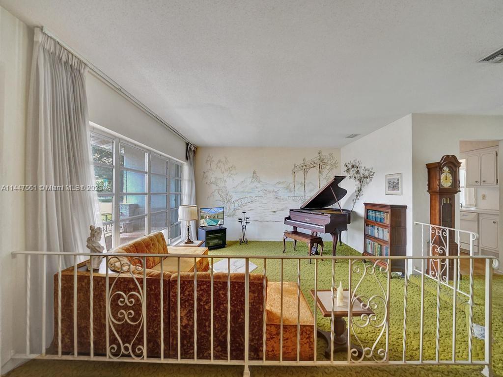 5525 Jackson Street Hollywood, FL 33021 - Photo 41 of 91 a living room with lots of furniture and a floor to ceiling window